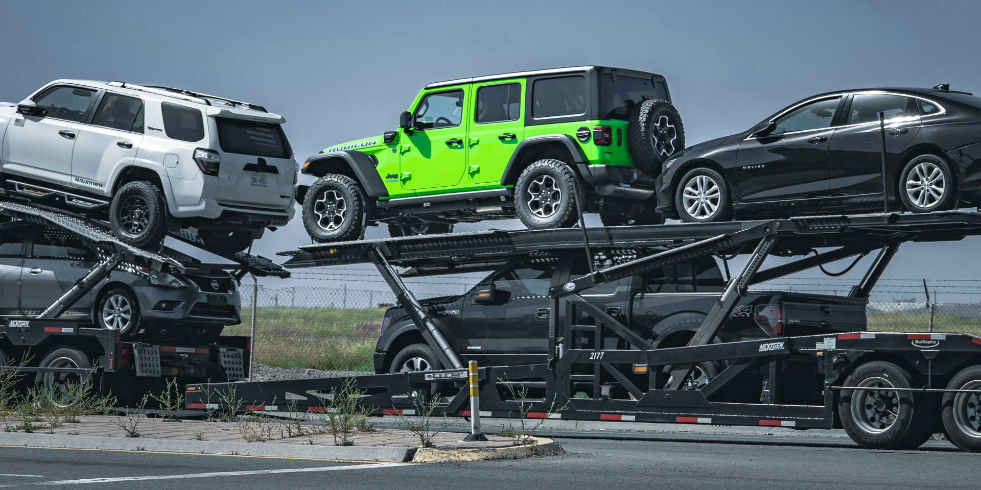 new vehicles loaded on a car transporter trailer
