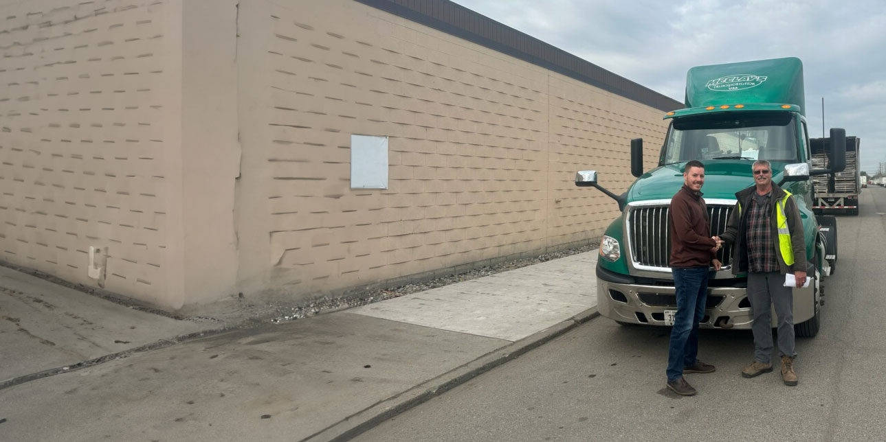 McClay's truck driver shaking a customer's hand