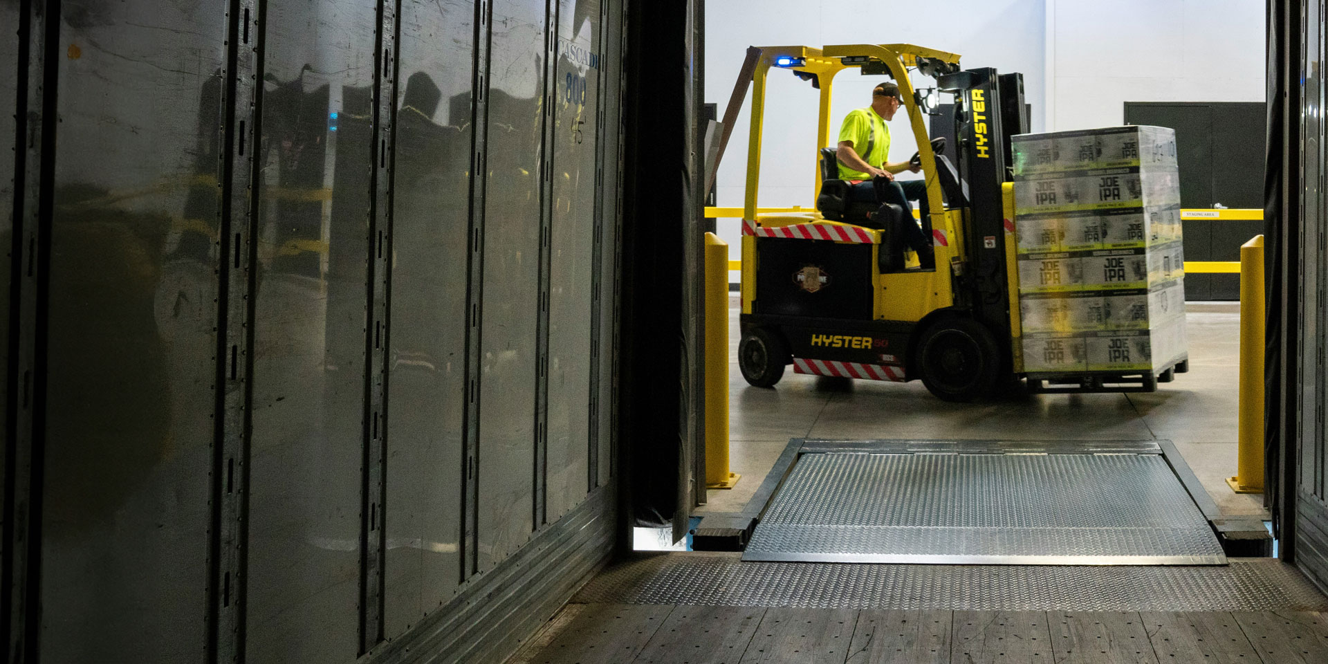 forklift operator loading an LTL load onto a trailer