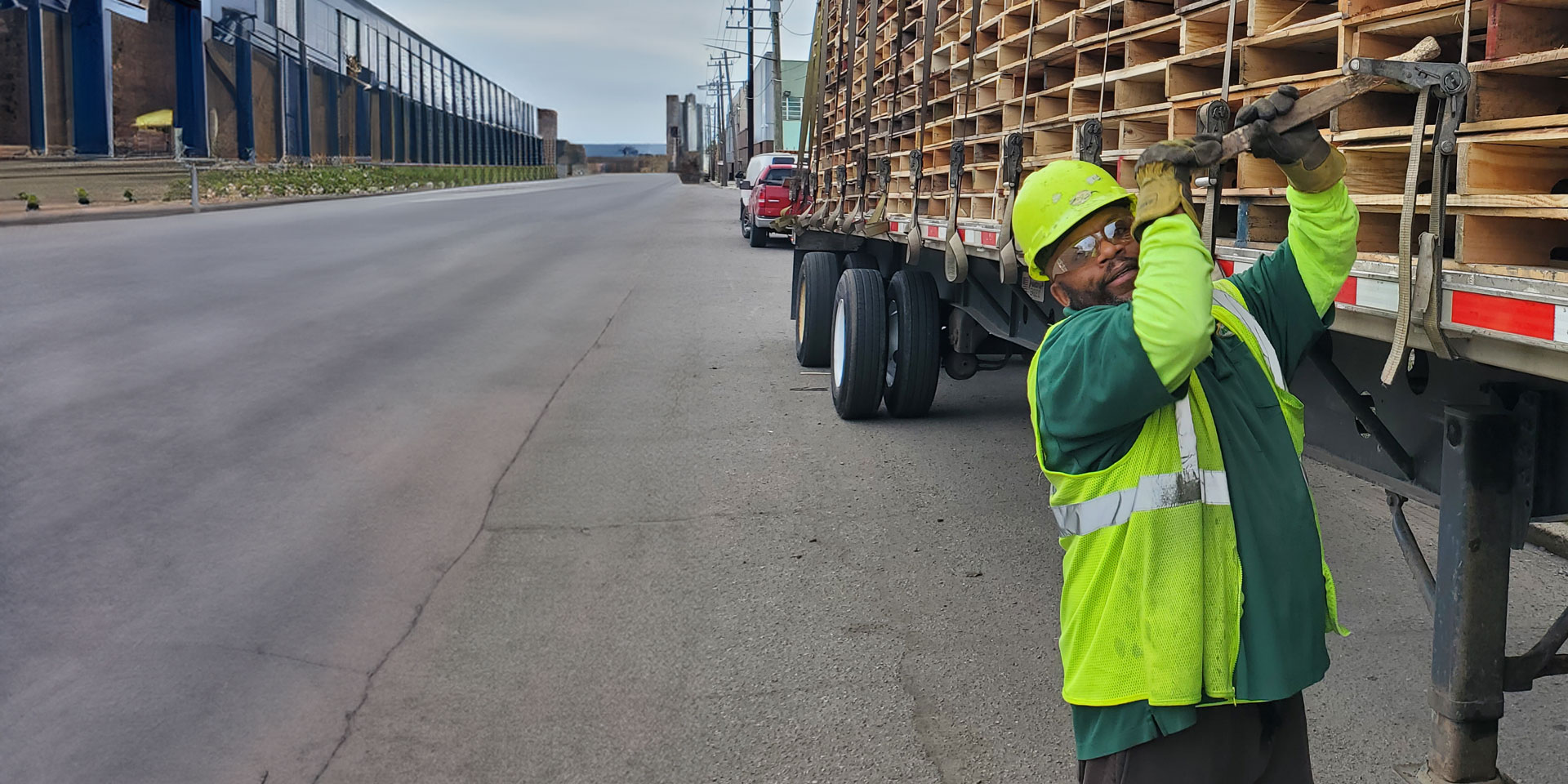 McClay's truck driver securing a flatbed load